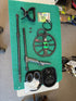 Collection of metal detecting equipment on a green mat
